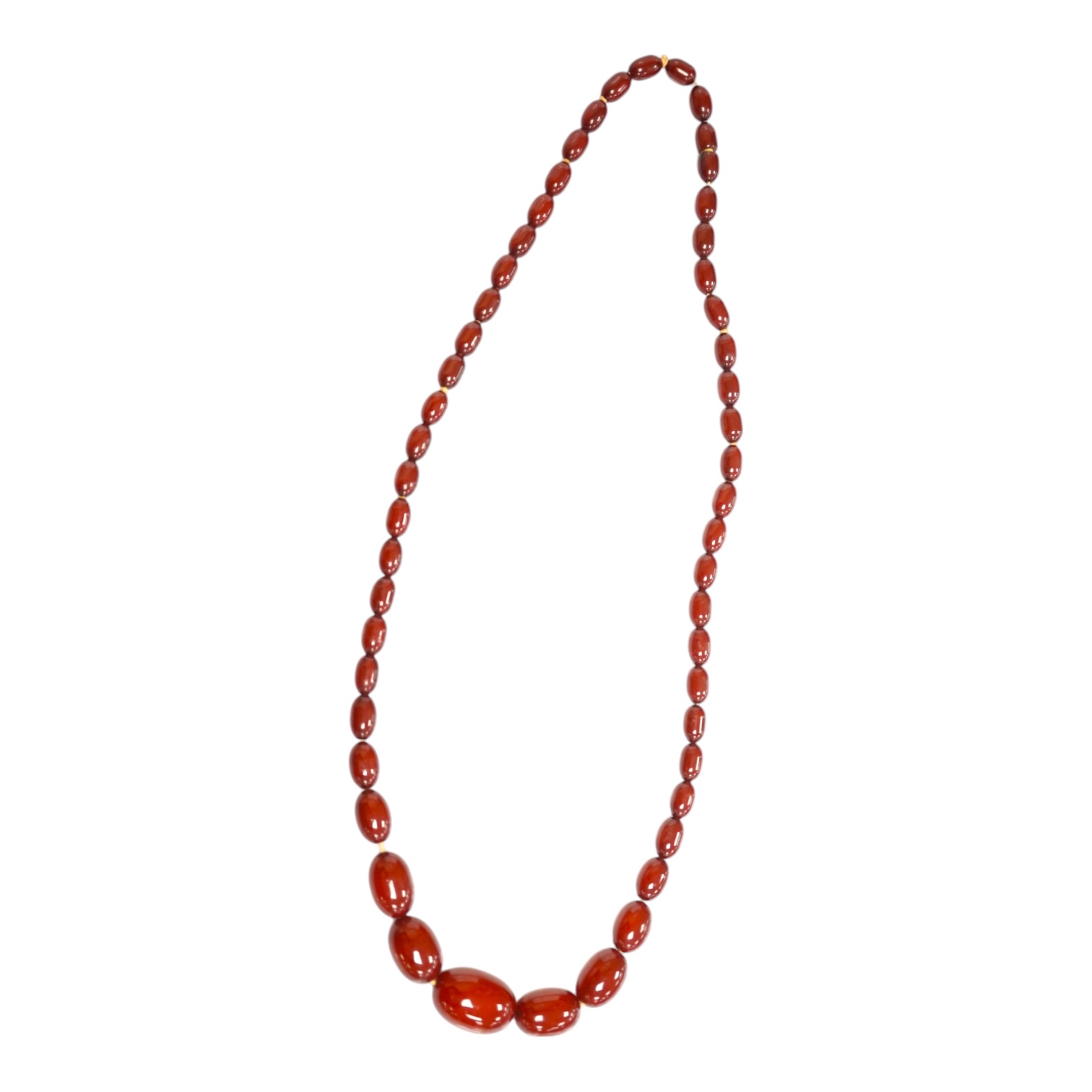 A single strand graduated simulated cherry amber oval bead necklace, 70cm, gross weight 51 grams. Condition - fair to good